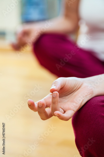 Two women working meditating at home, focus is on hands