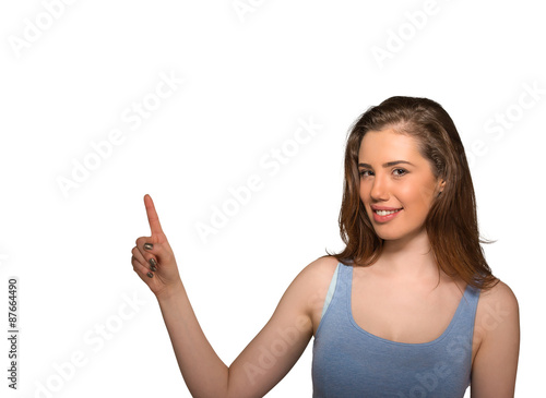 beautiful woman pointing with finger up to side at empty copy space