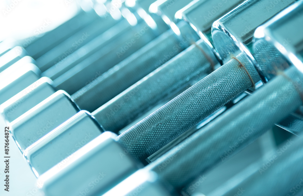 Row of dumbells side view in aqua blue tone Row of dumbells side view in aqua blue tone