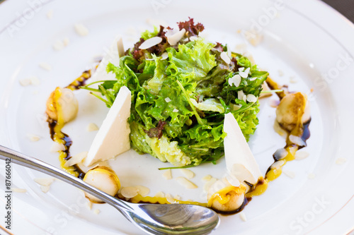 Fotografie Fresh salad with arugula, pear, feta cheese, almond flakes and aioli sauce