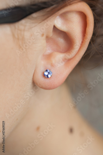 woman's ear with an earring