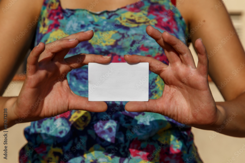 girl showing an empty white card girl showing an empty white card