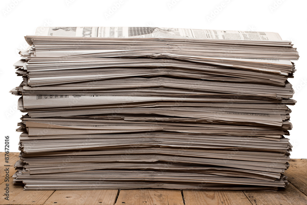 A stack of old newspapers on white background A stack of old newspapers on white background