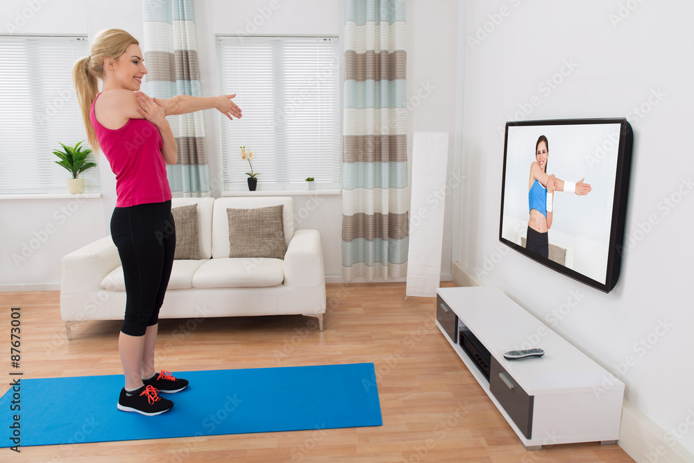 Woman Exercising In Living Room