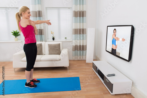 Woman Exercising In Living Room