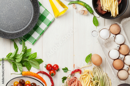 Pasta cooking ingredients and utensils on table