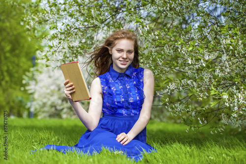 Beautiful young girl reading notebook © Andrey_Arkusha