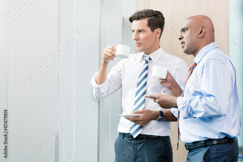 Asian and Caucasian business man having coffee