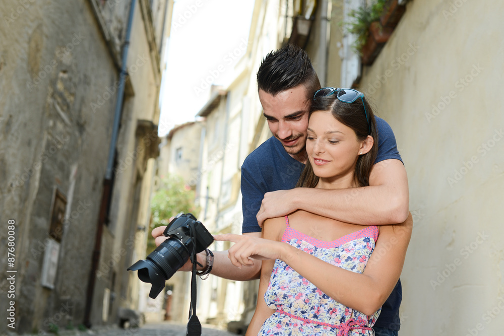 happy young couple tourist sightseeing and using a slr photo camera happy young couple tourist sightseeing and using a slr photo camera