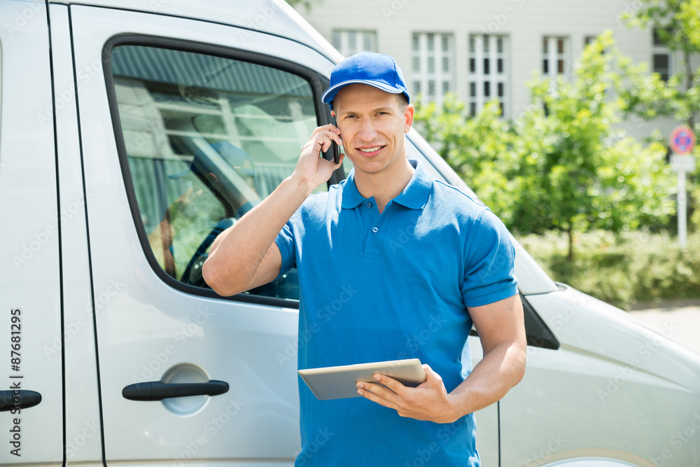 Naklejka premium Worker With Mobile Phone And Digital Tablet
