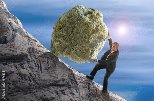 Bild auf Leinwand Sisyphus metaphor man rolling huge rock ball up hill