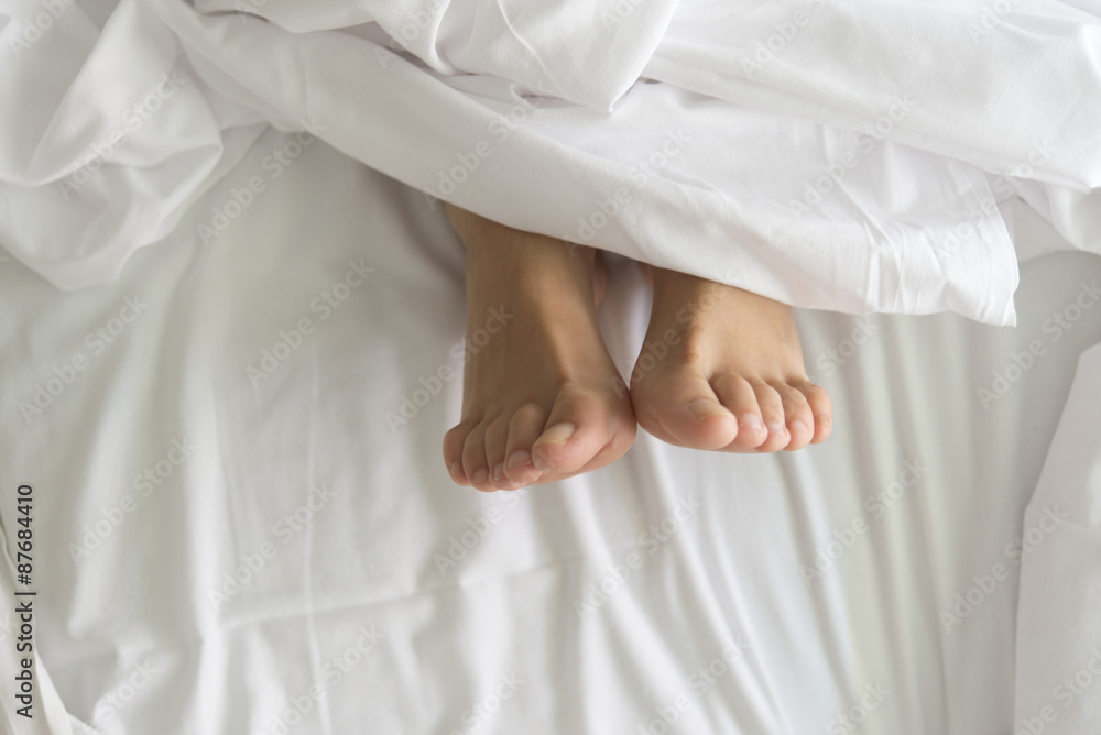 Two feet in a bed against a white background Two feet in a bed against a white background