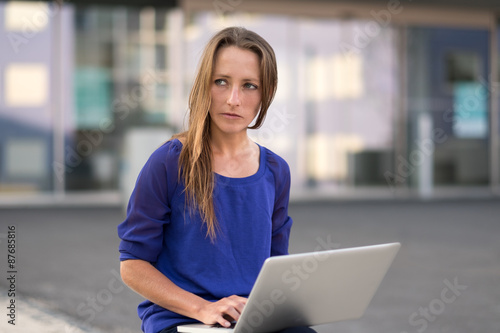 Woman working on a laptop on her lap