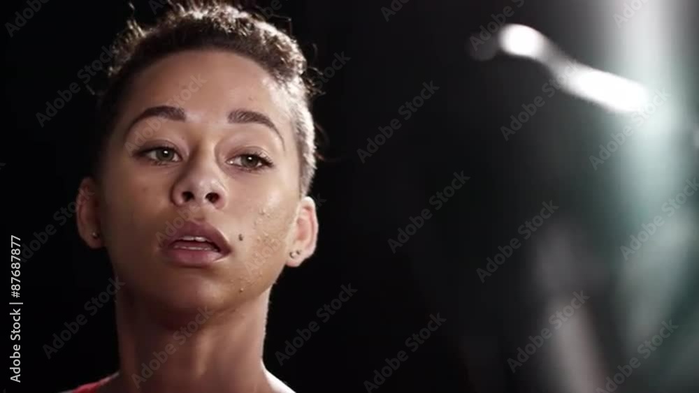 Black Woman sparring with a boxing trainer Black Woman sparring with a boxing trainer