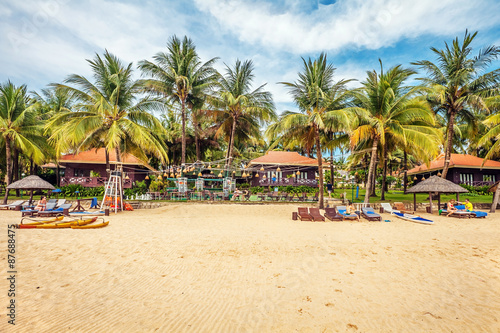 Tourists sunbathing on the sand of a tropical beach