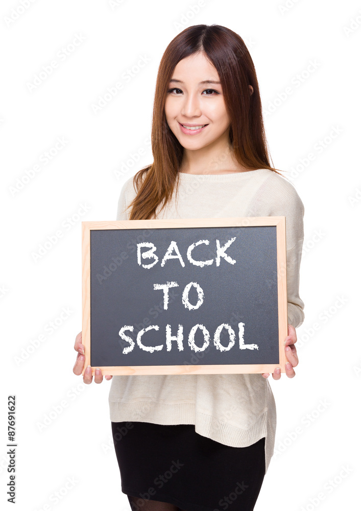 Woman hold with chalkboard showing back to school message Woman hold with chalkboard showing back to school message