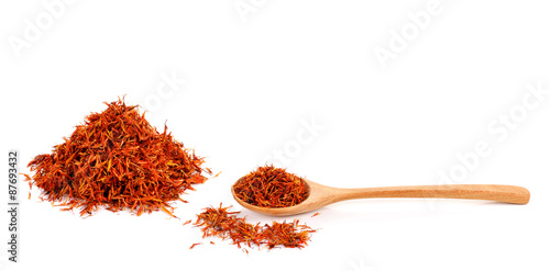 Valokuva Safflower petals in a spoon on white background