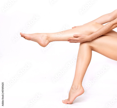 Long woman legs isolated on white. Depilation or another healths concept
