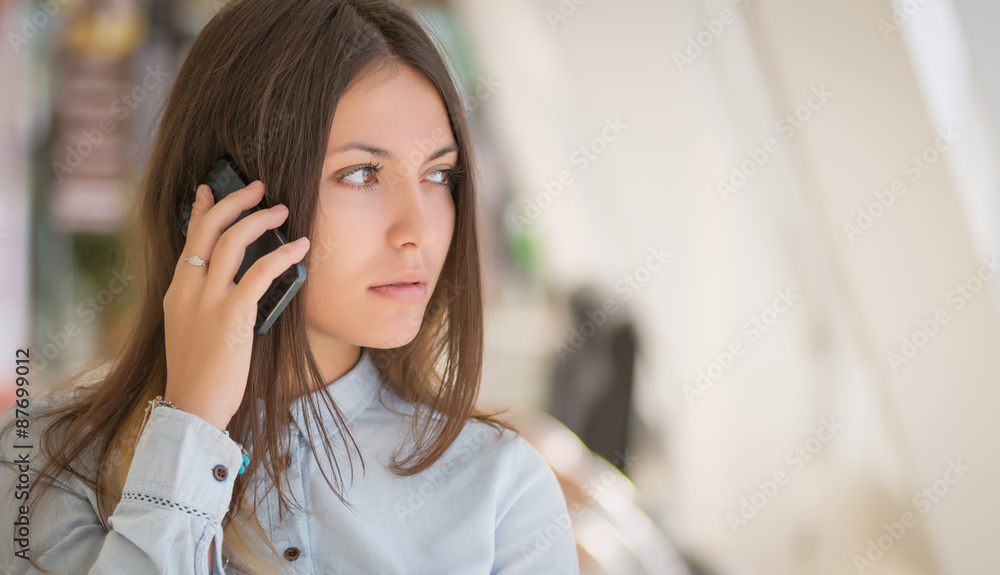 Portrait of a young businesswoman talking on the phone. Portrait of a young businesswoman talking on the phone.