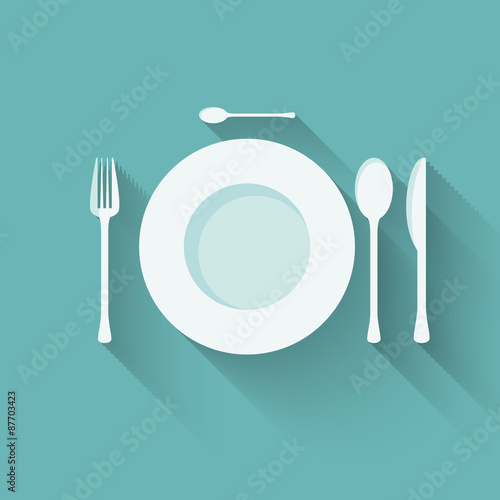 flat plate and cutlery with long shadows