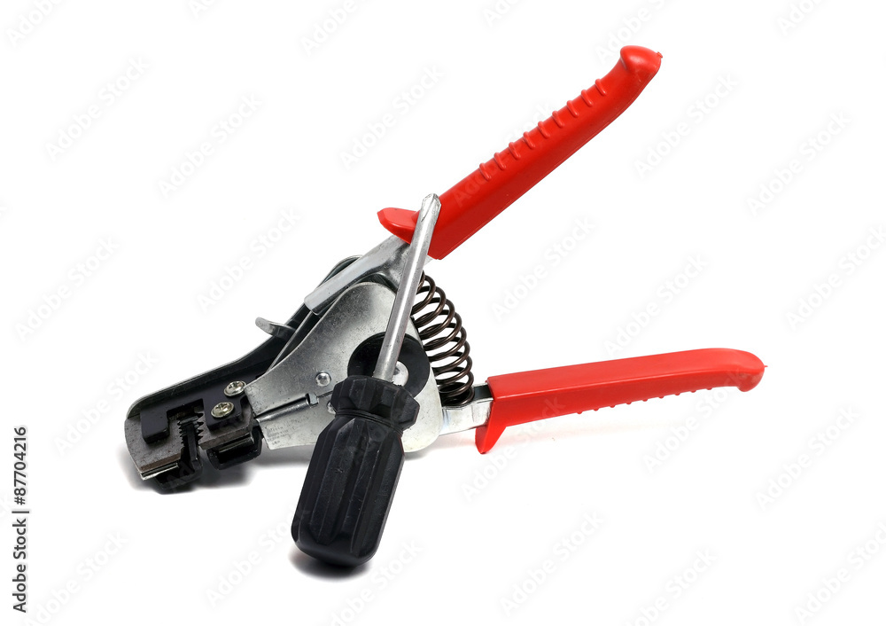 solid insulation stripper and screwdriver on a white background solid insulation stripper and screwdriver on a white background