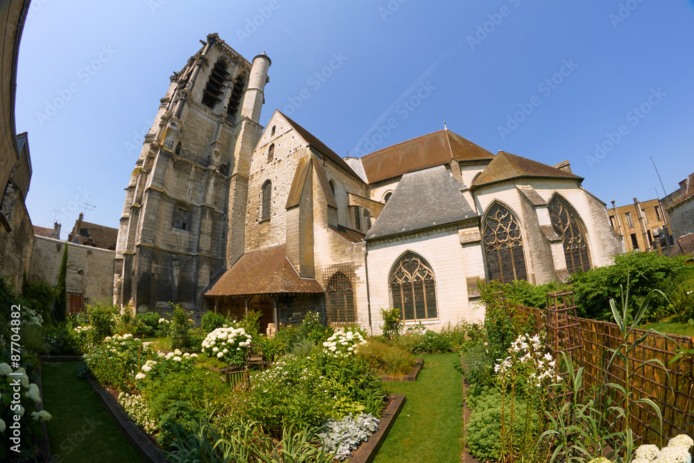 Garden with a medieval church in the city of Troyes, France