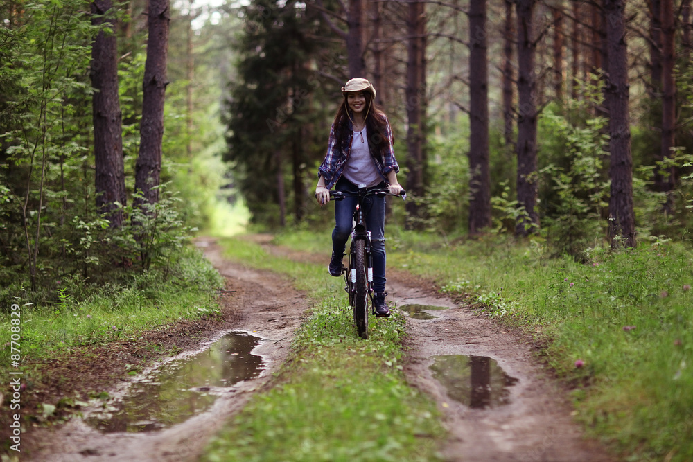 young girl on a sports bike in a summer forest young girl on a sports bike in a summer forest