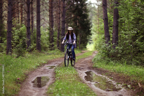 young girl on a sports bike in a summer forest © kichigin19