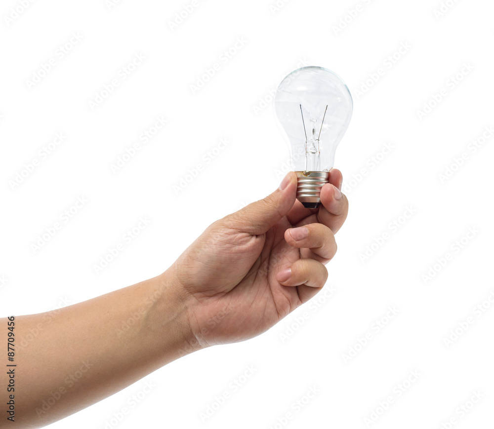 Hand holding an incandescent light bulb isolated on white backgr Hand holding an incandescent light bulb isolated on white backgr