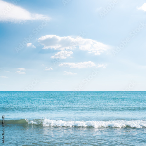 wave on sea and blue sky with clouds