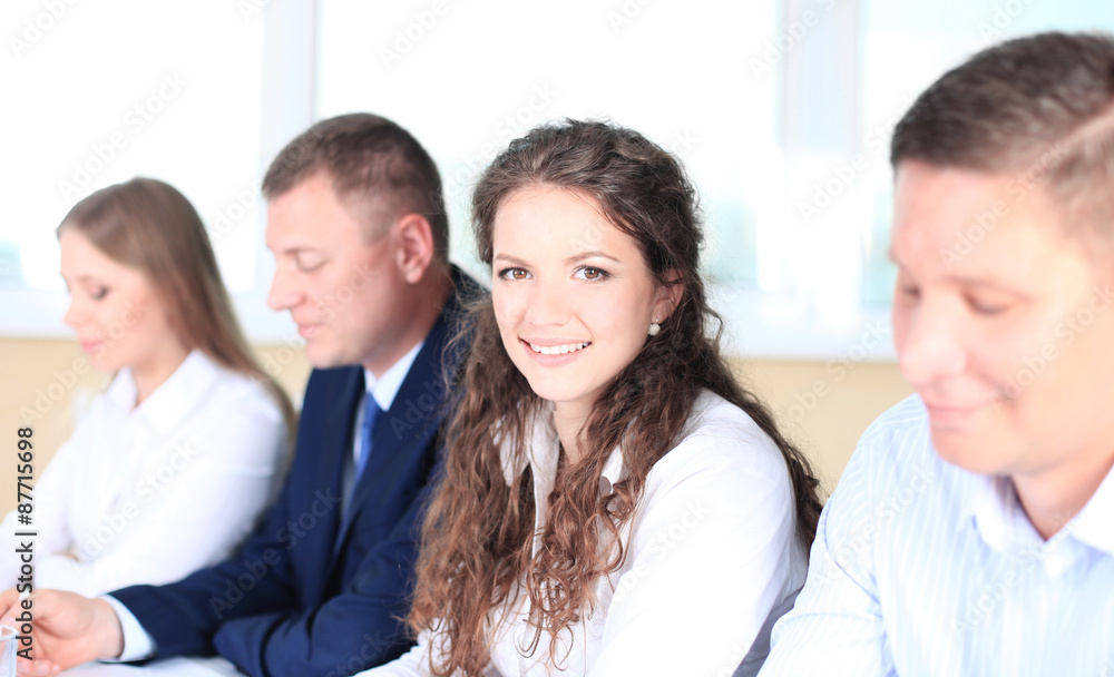 Smiling businesswoman looking at camera at seminar 
