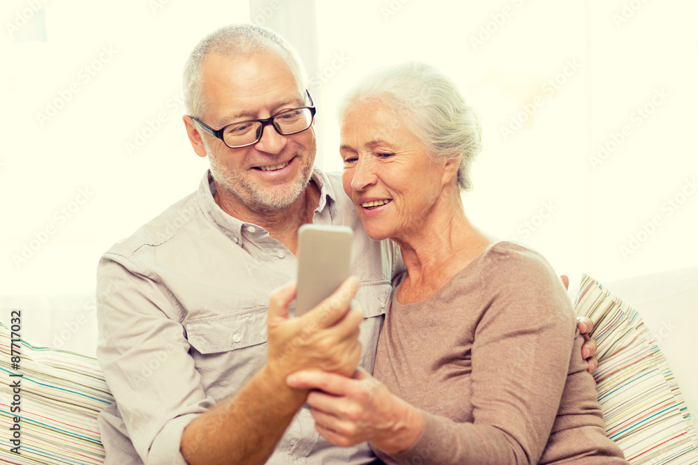 happy senior couple with smartphone at home happy senior couple with smartphone at home