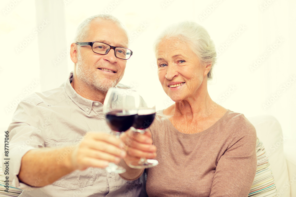 happy senior couple with glasses of red wine happy senior couple with glasses of red wine