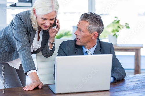 Wallpaper Mural Businesswoman having phone call and looking at laptop  Torontodigital.ca