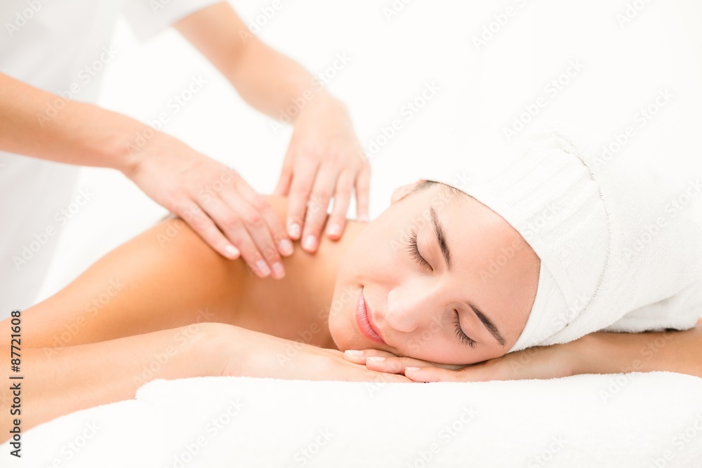 Attractive young woman receiving shoulder massage Attractive young woman receiving shoulder massage