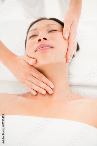 Attractive young woman receiving head massage 