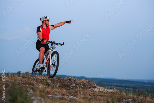 Biker riding on bicycle in mountains