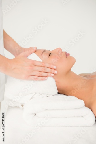 Attractive young woman receiving facial massage 