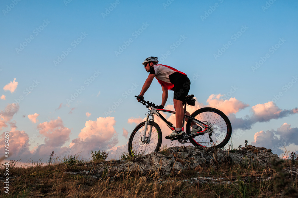 Biker riding on bicycle in mountains Biker riding on bicycle in mountains