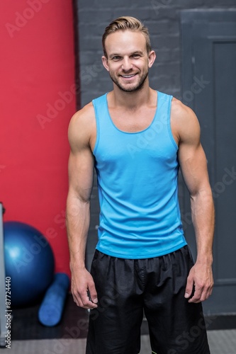 Muscular man smiling at camera