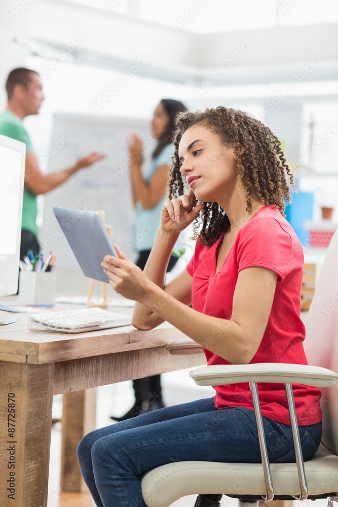 Businesswoman using a digital tablet in office Businesswoman using a digital tablet in office