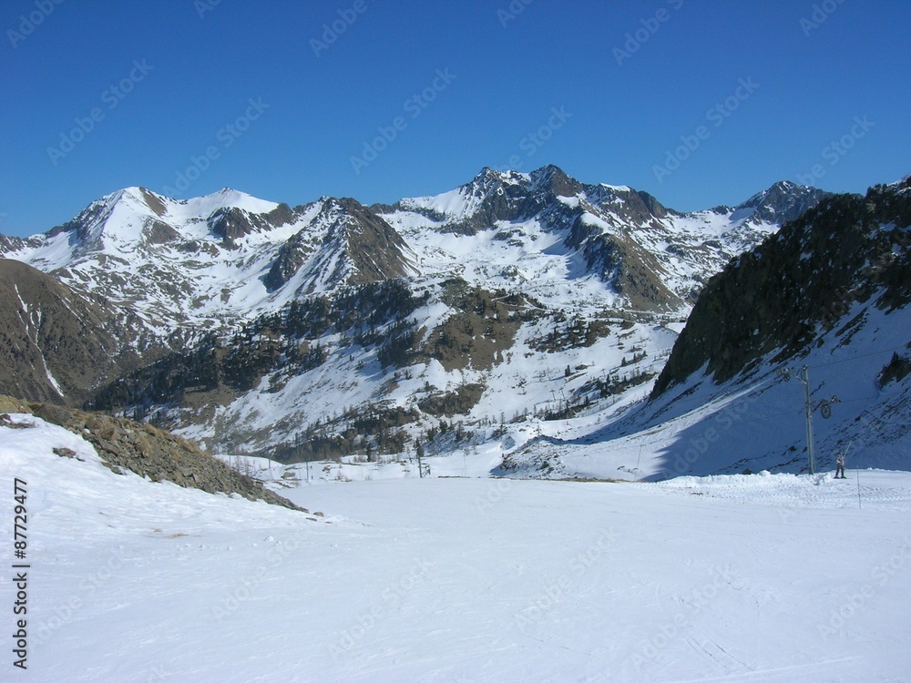 Snowy winter landscape in the mountains, in the French ski resort Isola 2000 in the Alps, on a sunny day.