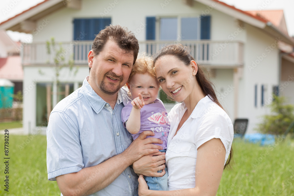 Happy family having fun in front of house Happy family having fun in front of house