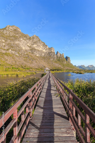 Wooden Bridge in lotus lake on sunset time at Khao Sam Roi Yot National Park, Thailand