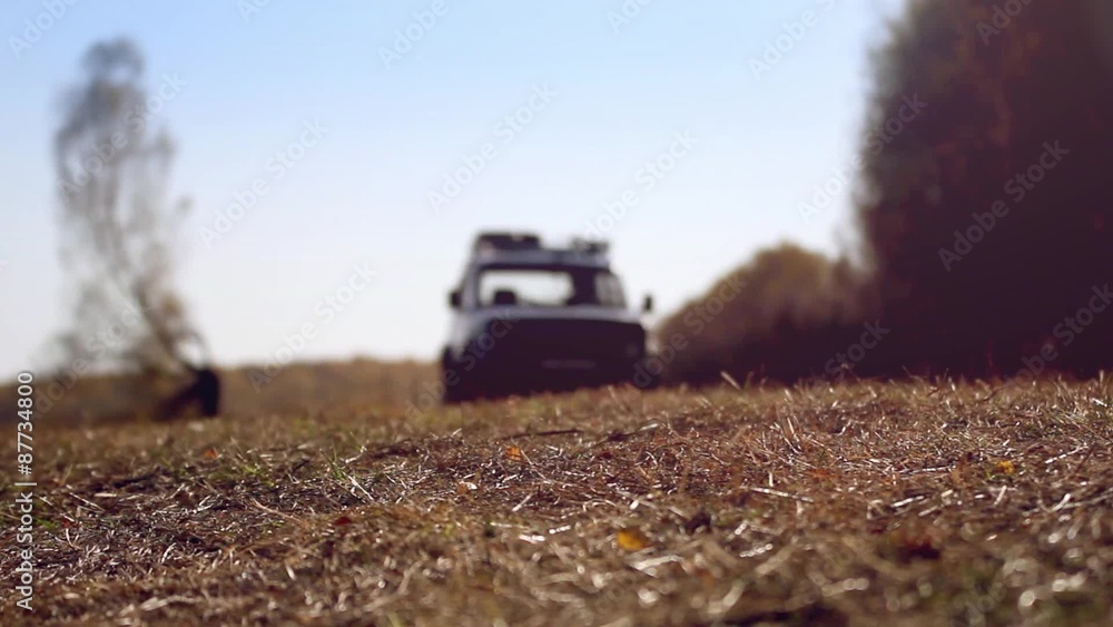 Off road SUV vehicle running in autumn forest on road Off road SUV vehicle running in autumn forest on road