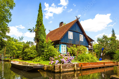 beautiful old half-timbered house on a water canal in the spreewald, brandenburg, germany