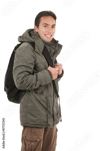 happy young guy wearing jacket and a backpack