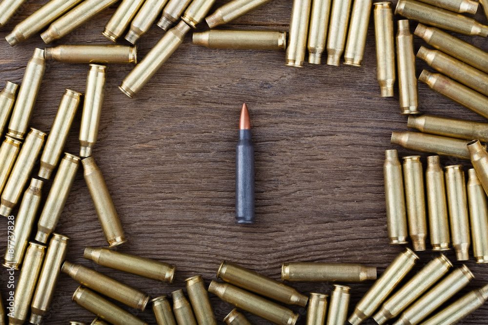 Ak-47 cartridges on wooden table close-up. Ak-47 cartridges on wooden table close-up.