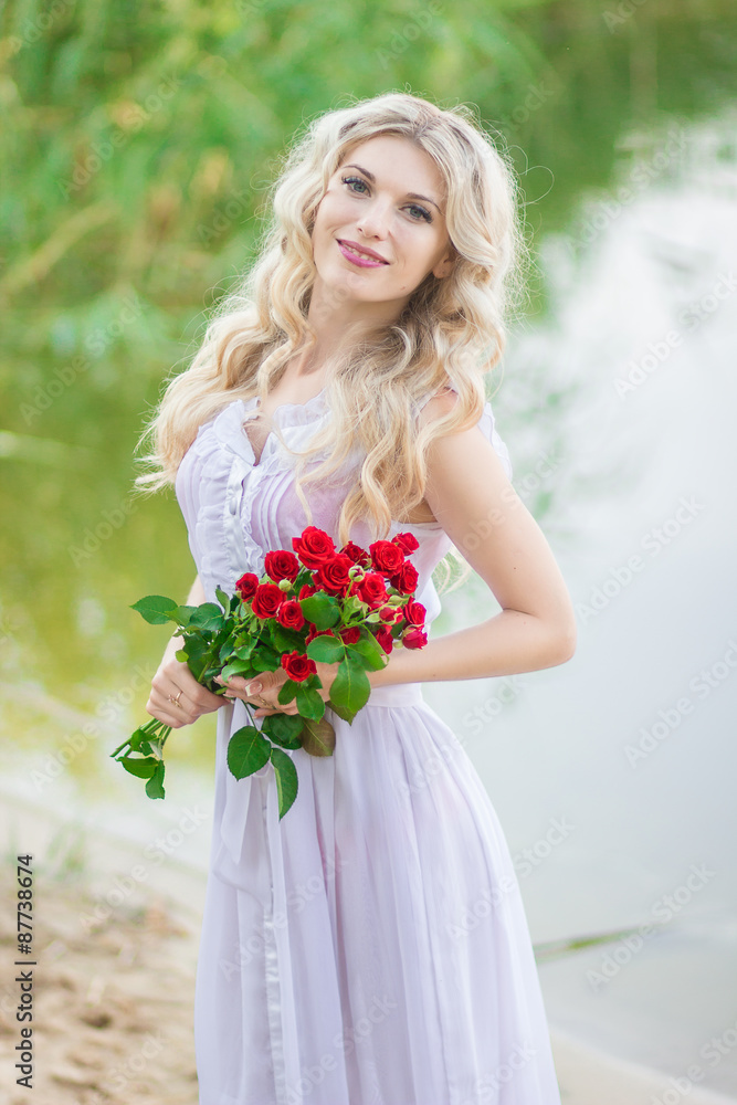 beauty woman portrait with a bouquet of red roses