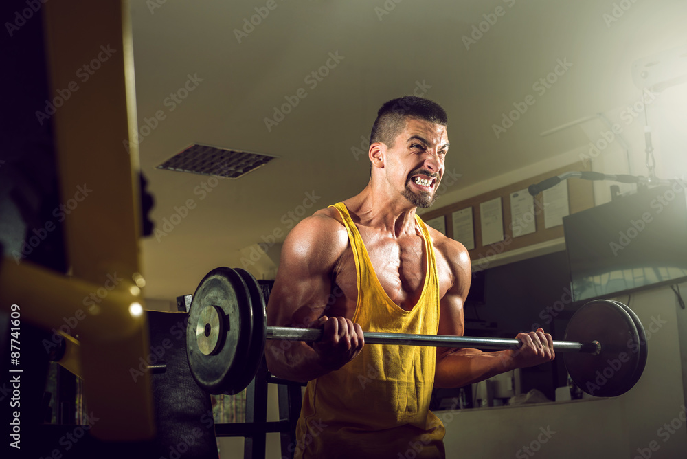 Young man doing barbell exercise in gym Young man doing barbell exercise in gym